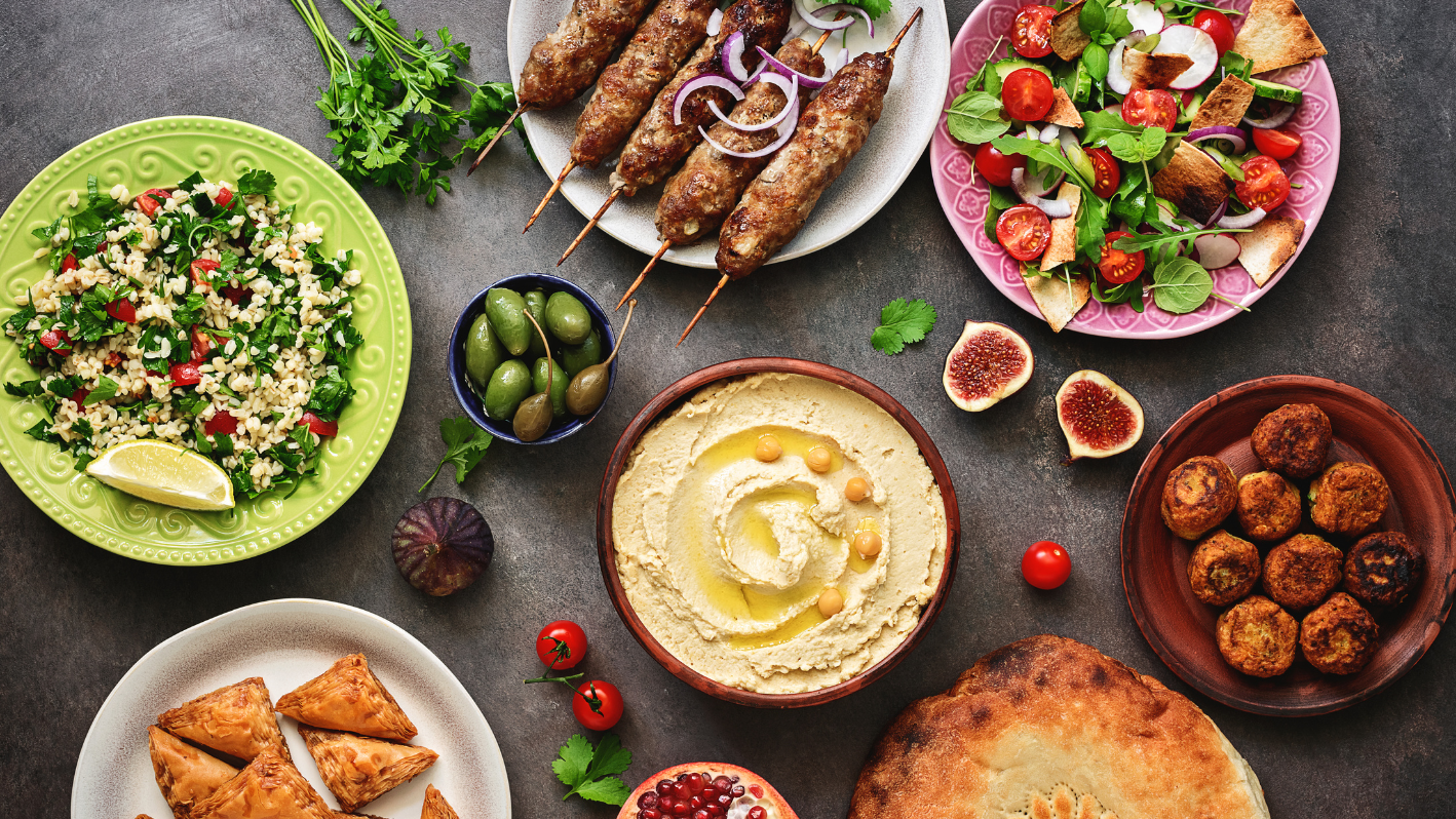 A table topped with lots of plates of food