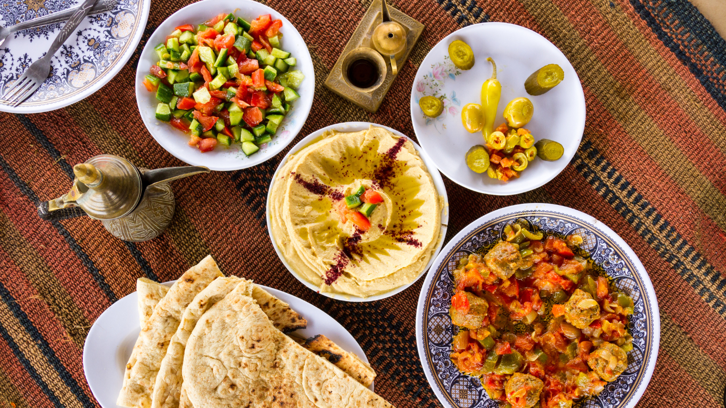 A table topped with plates of food and bowls of food