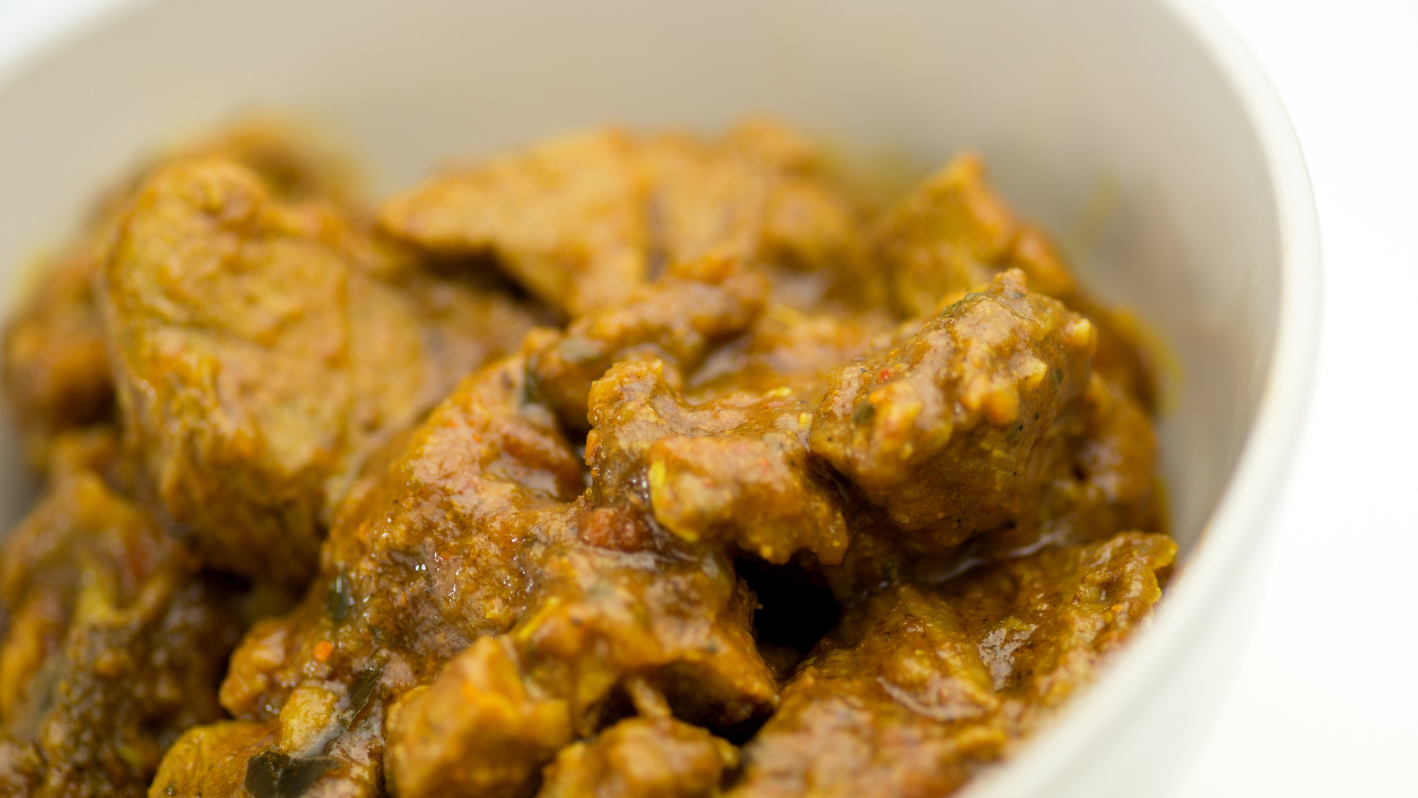 A close up of a bowl of food with meat