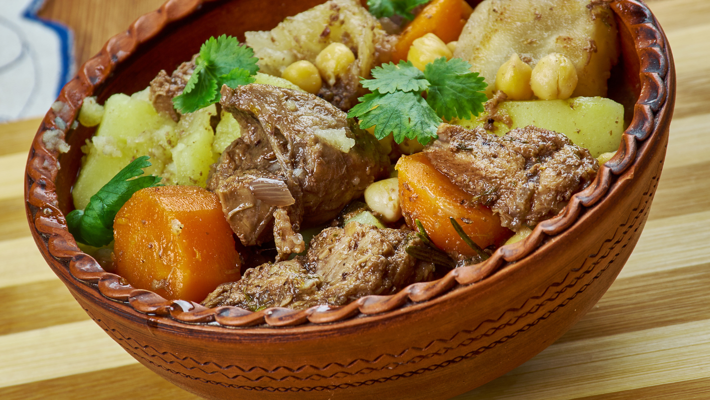 A bowl filled with meat and vegetables on a table